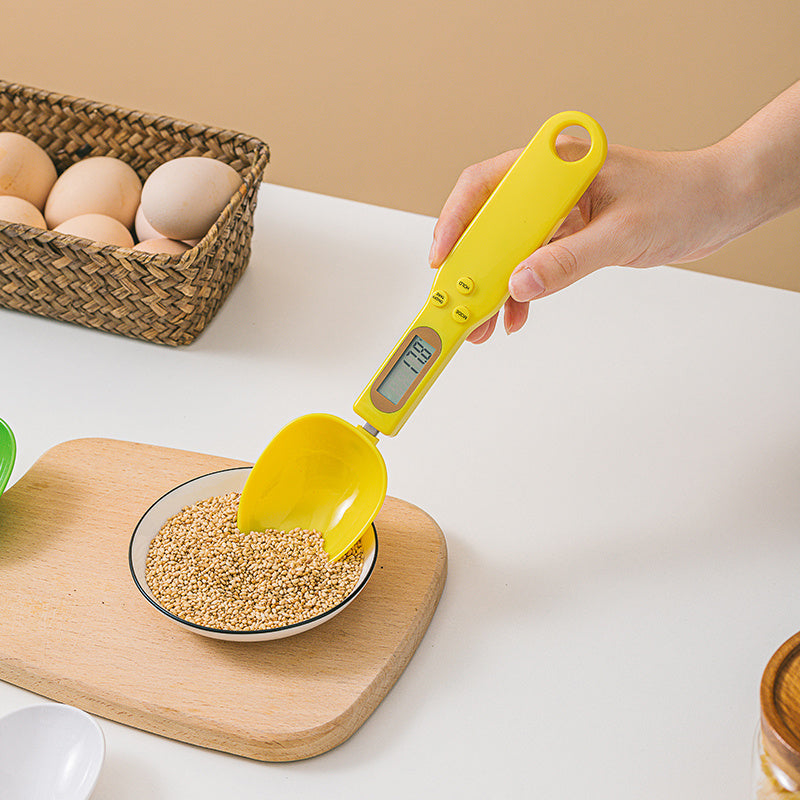 LCD Digital Spoon Scale UK measuring seeds in a bowl with a yellow spoon design.