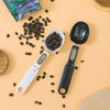 LCD Digital Spoon Scale UK with coffee beans on an orange background for precise measuring in cooking.