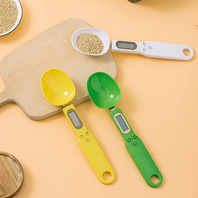 LCD Digital Spoon Scale UK with colorful measuring spoons on a kitchen countertop for precise cooking measurements.